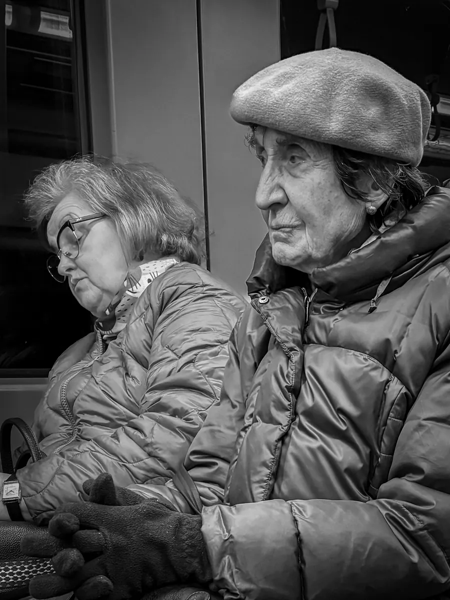 Two elderly women, one wearing a beret