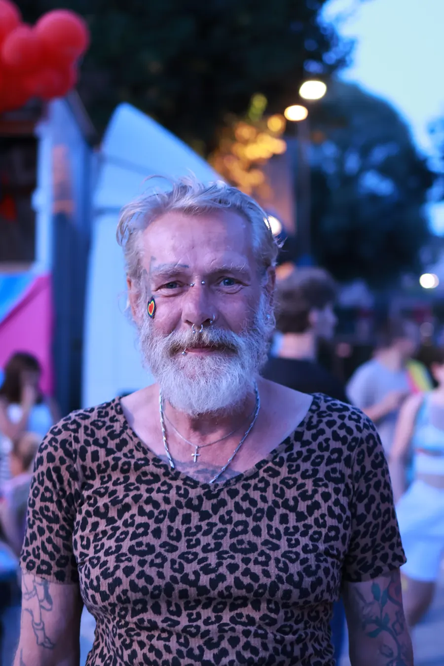 Smiling bearded man in leopard print at Pride