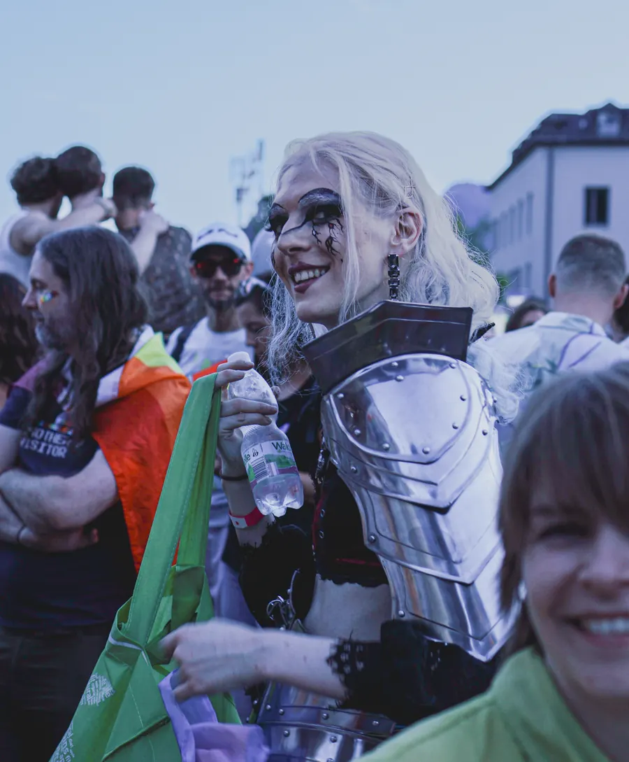 Smiling woman in silver armour costume in the Pride crowd