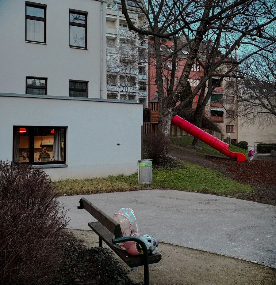 Bench with a forgotten bag, red slide in the background